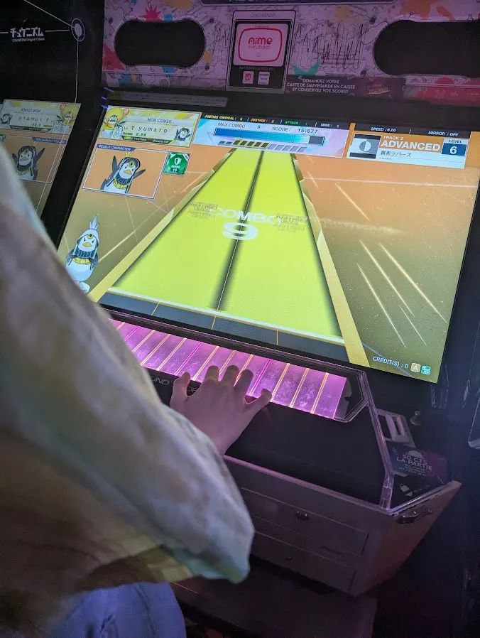 Picture of a friend playing CHUNITHM Paradise (I Believe?); Two faced Lovers by wowaka in ADVANCED difficulty.
