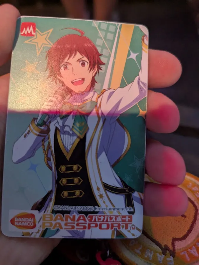 Picture of a Bana Passport faturing Teru Tendo in his Nandodemo Waraou outfit. A Bana Passport is a card used to save your data in Arcade Games.
